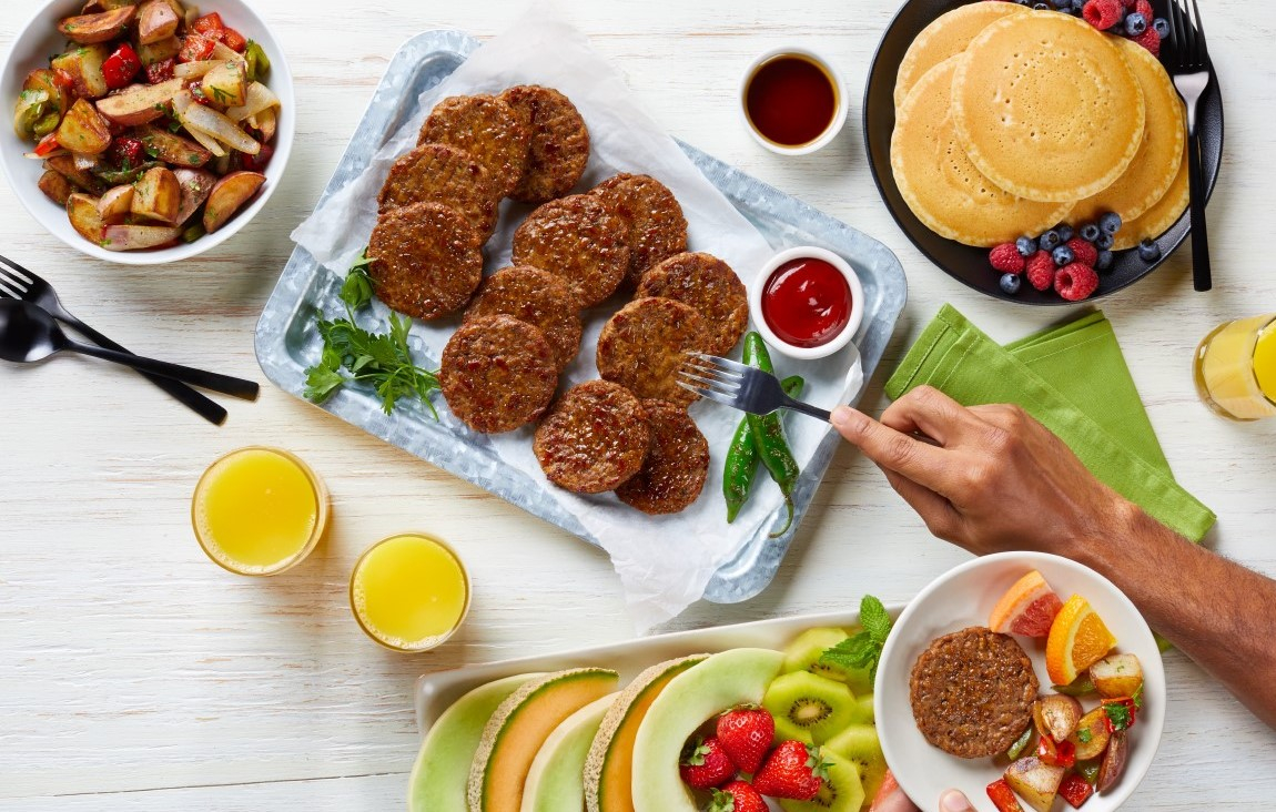 Beyond Breakfast Sausage on a tray with potatoes pancakes and fruit